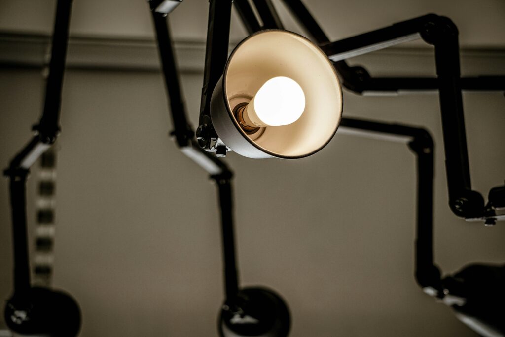 A stylish lamp with a light bulb hanging down, providing soft lighting and enhancing the ambiance of the space.
