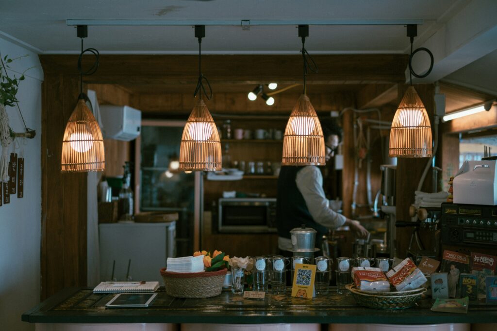  An inviting space showcasing a counter with a few stylish lamps hanging overhead.