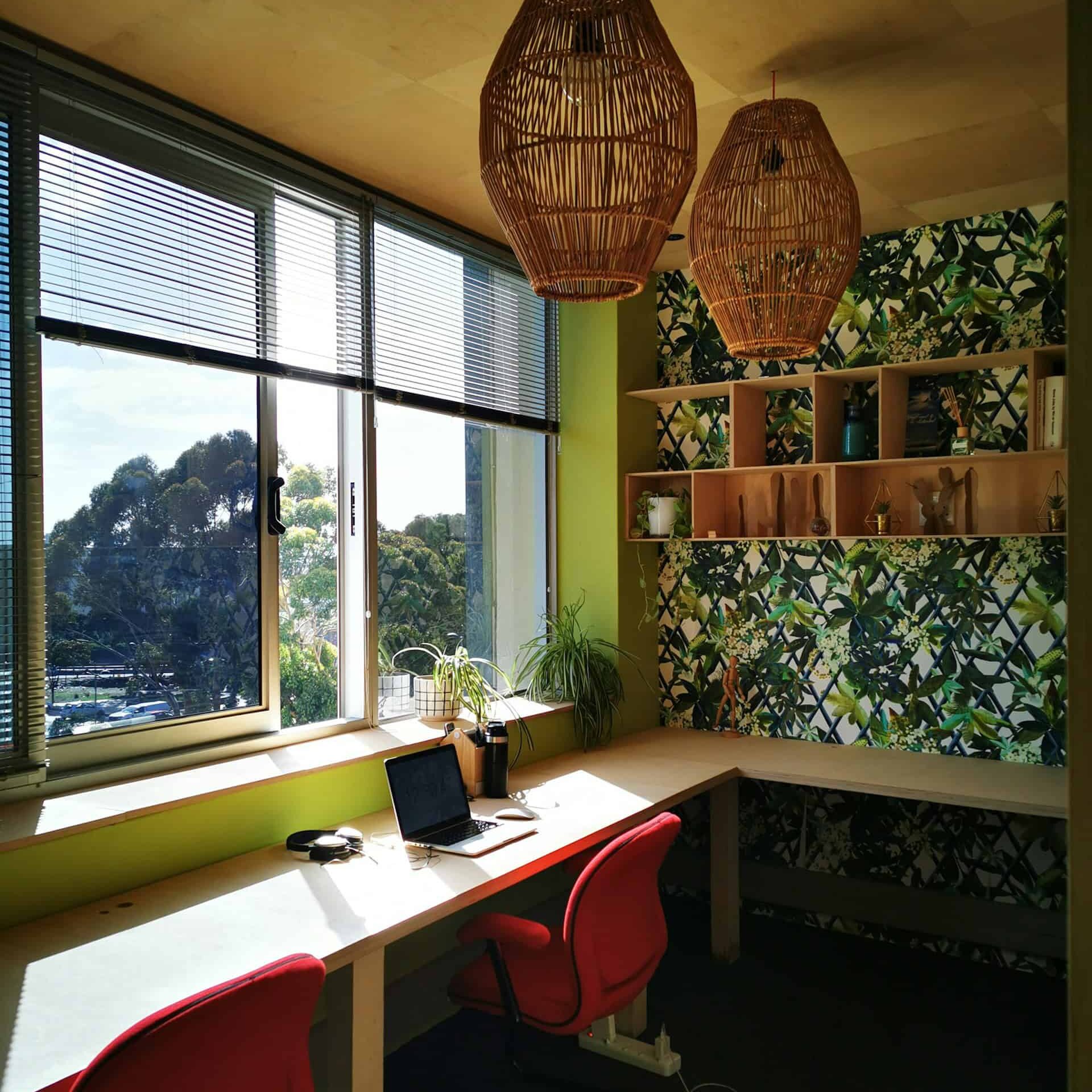 A desk with a laptop and a chair positioned in front of a window, allowing A desk with a laptop and a chair positioned in front of a window, allowing natural light to illuminate the workspace.