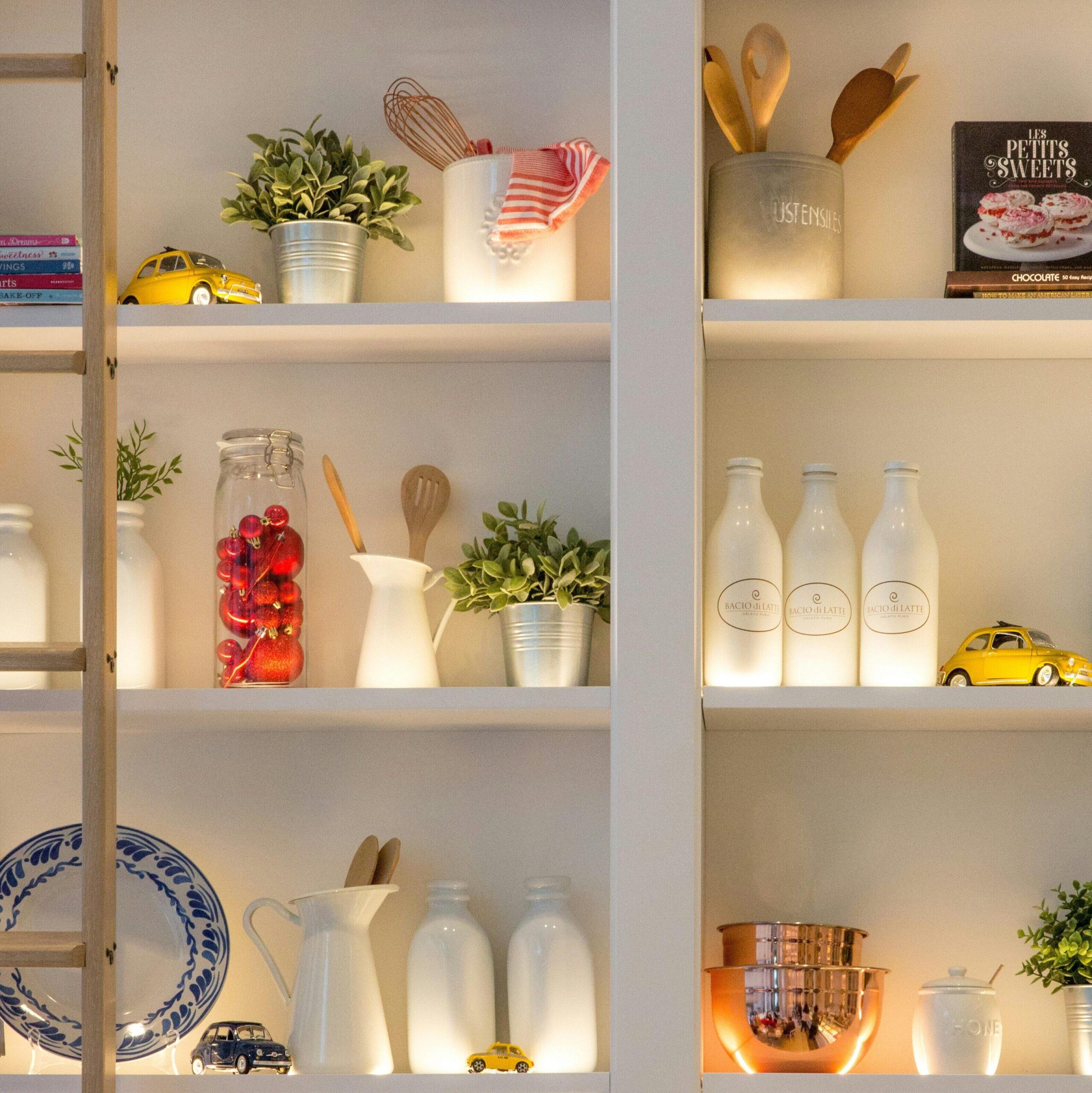 Small Apartment Decor Ideas: 9 Creative Solutions for Maximizing Space and Style A well-arranged kitchen with shelves displaying an assortment of items, highlighting a blend of utility and aesthetics.