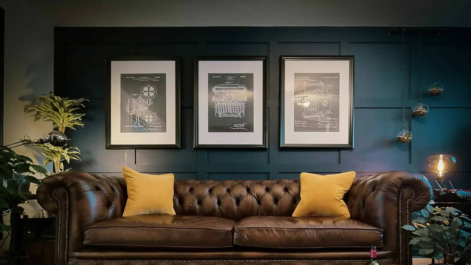A cozy living room featuring the best sofa, a leather couch, and framed pictures adorning the walls.