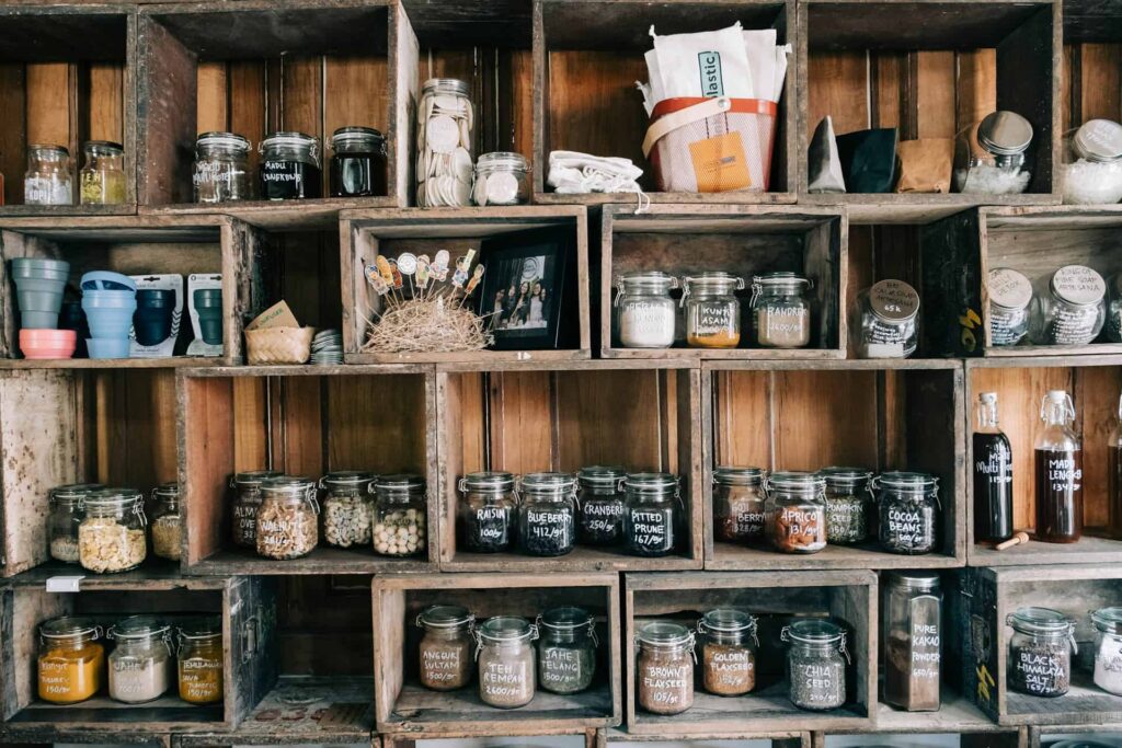 A rustic shelf brimming with jars of diverse foods, enhancing the farmhouse kitchen decor aesthetic.