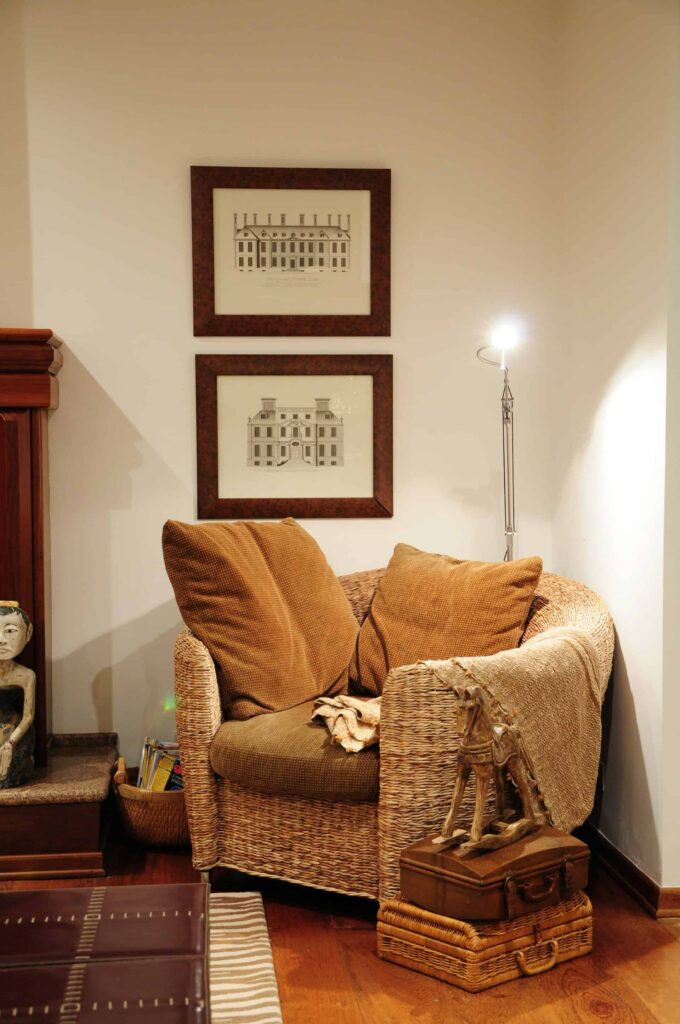 A brown couch adorned with a white pillow, exemplifying stylish boho furniture for a cozy living space