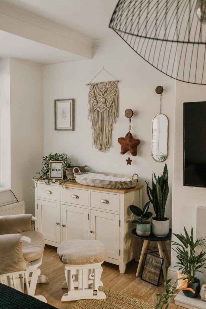 A white dresser with a mirror, a television, and a lamp arranged neatly on top.