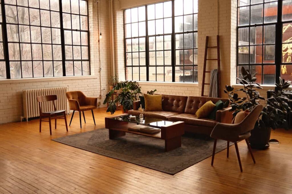 an industrial  living room featuring a comfortable couch, a stylish chair, and a modern table, creating an inviting atmosphere.